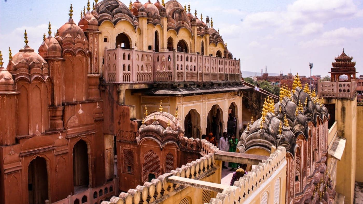 Historic Rajput architecture with domes and arched corridors at City Palace in Jaipur, Rajasthan.