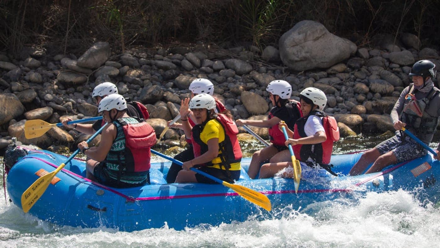 Suspension bridge over the Ganges River with scenic hills and city view in Rishikesh, Uttarakhand.