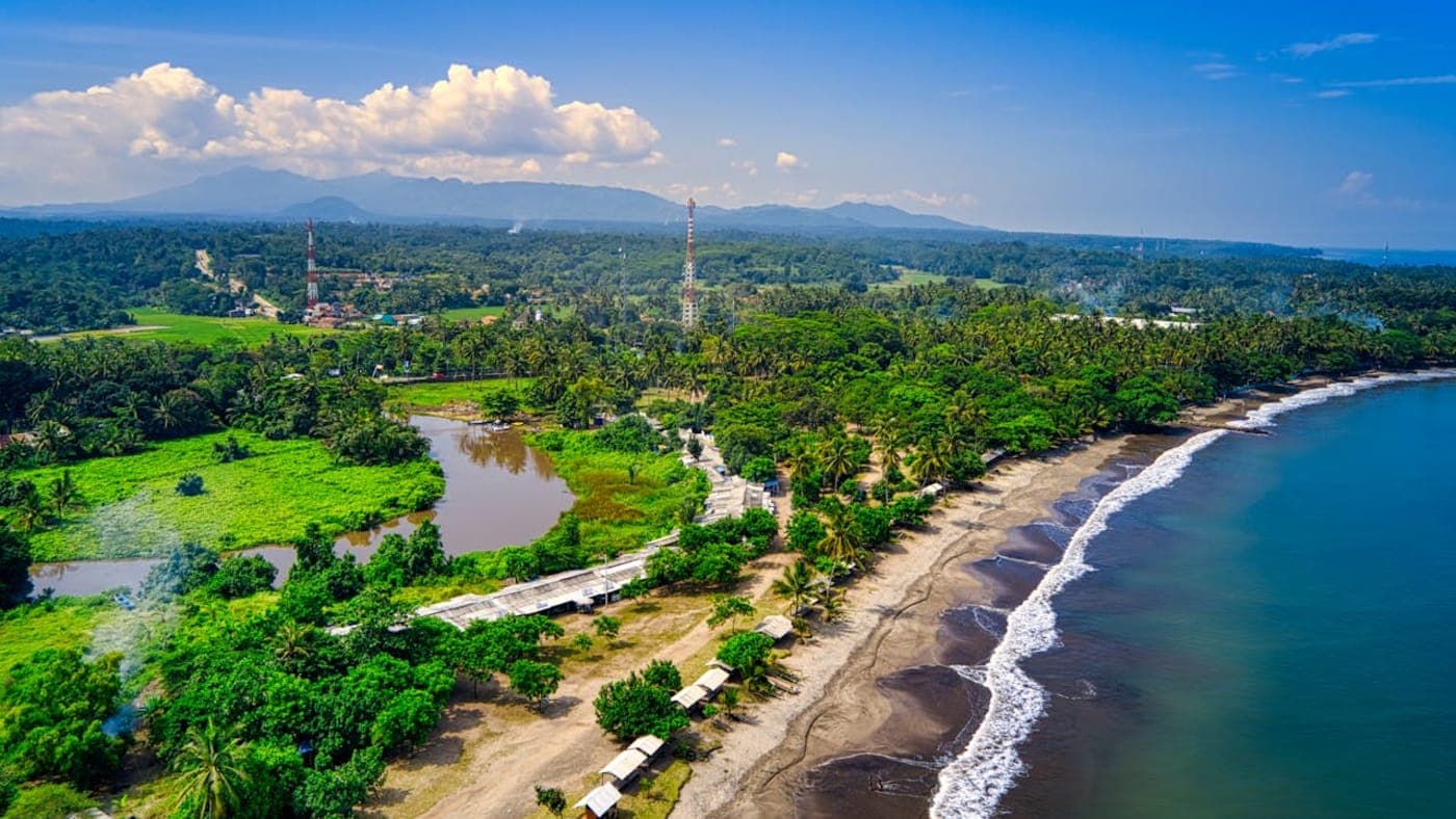 Aerial view of Broken Beach with circular rock arch and turquoise ocean on Nusa Penida, Bali.