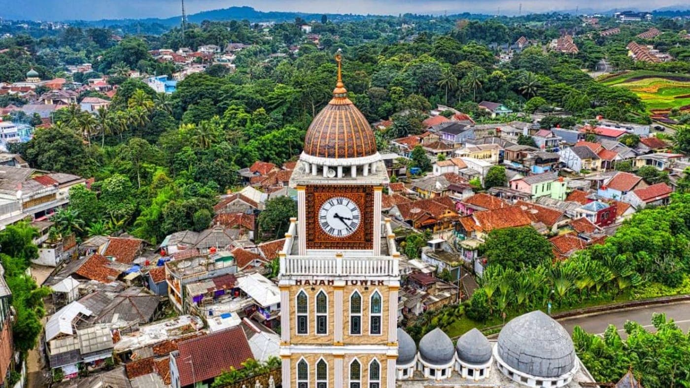 Traditional multi-tiered Balinese temple shrines at Pura Besakih surrounded by lush greenery and misty mountain views in Bali.