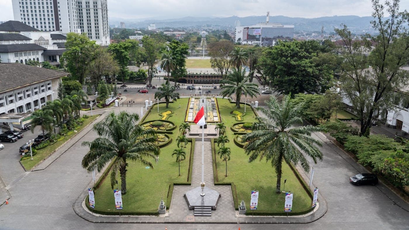 Pura Ulun Danu Bratan temple on Lake Bratan with mountains and sunrise sky in Bali, Indonesia.