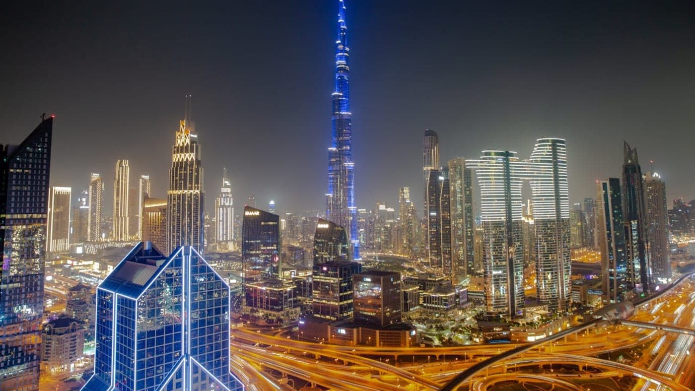 Dubai Marina skyline at night with illuminated skyscrapers and waterfront reflections in Dubai, UAE.