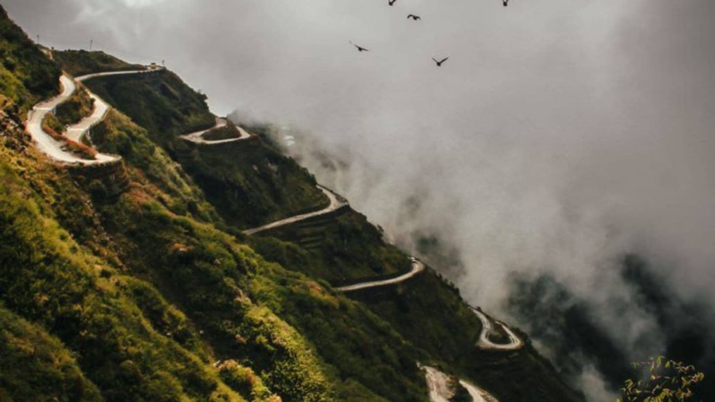 Beautiful mountain road near Gangtok covered in mist, offering panoramic views of Sikkim's lush Himalayan valleys